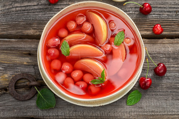 Delicious fruit soup with cherries, apples and mint