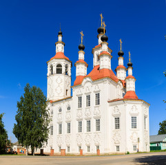 Fototapeta na wymiar Russian white orthodox Temple of the Entry of the Lord into Jerusalem against the blue sky The Nativity Church, Totma, Russia. Architectural forms reminiscent of a ship.