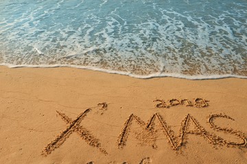 Happy new year concept, 2019 Xmas handwriting on sand beach.