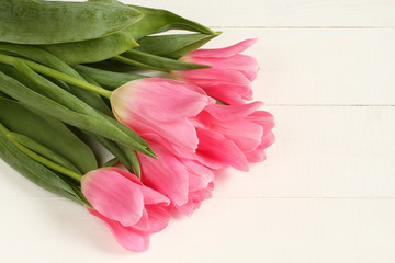 Pink tulip flowers on white painted wooden table