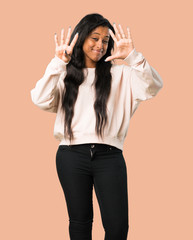Young afro american woman counting nine with fingers on isolated brown background