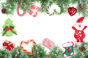 Christmas Frame of Fir tree branch with candy canes and boxes isolated on white background with copy space for your text