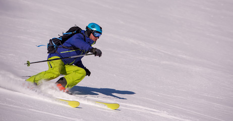 Skier having fun while running downhill