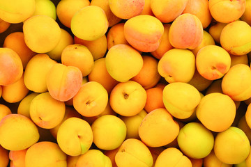 Ripe juicy orange apricots fruit background.