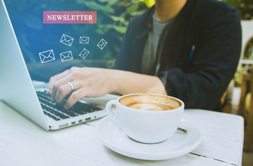 newsletter concept Hand of businessman or designer checking message box on digital laptop, blank black space for your text