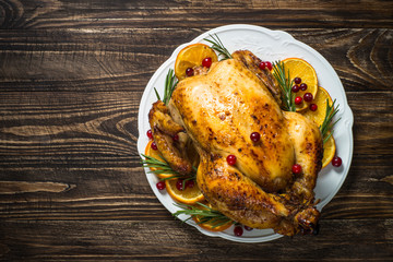 Chrismas chicken baked with cranberry, orange and rosemary. Christmas dinner.