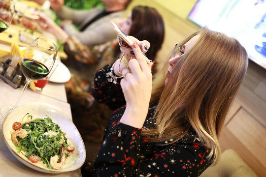 Teen takes picture of salad