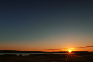 Fototapeta na wymiar Picturesque view of beautiful sunrise on riverside. Morning sky
