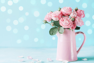 Beautiful rose flowers in pink vase for Womens day or Mothers day greeting card.