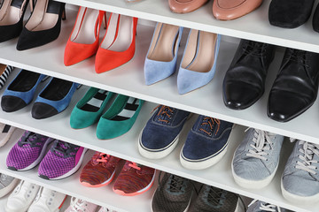 Shelving unit with different shoes. Element of dressing room interior