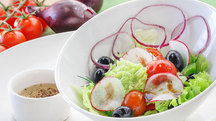 Salad with fresh vegetables in a white plate