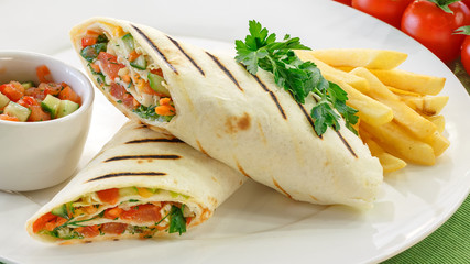 Shawarma with vegetables on a white plate