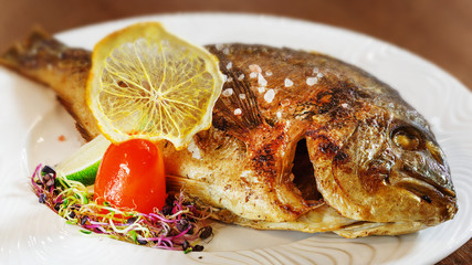 Fried fish in the plate, dinner