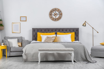 Stylish room interior with large comfortable bed