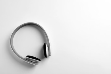 Stylish modern headphones with earmuffs on white background, top view. Space for text