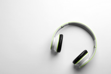 Stylish modern headphones with earmuffs on white background, top view. Space for text