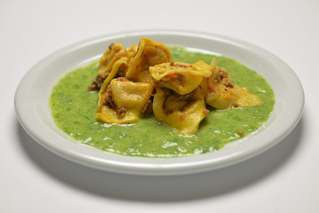 cappelllacci with ragù on vegetable cream
