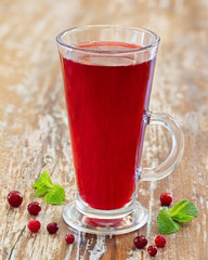 Berry juice, juice in a glass on a wooden background