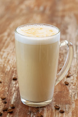 Coffee with milk, latte, cappuccino in a cup on a wooden background