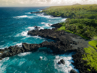 Black sand beach rocks and ocean