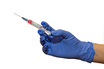 hands in rubber gloves with two syringes and cotton wool on a white background. Doctor in medical glove holding syringe on white background. 