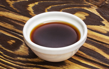 Soy sauce on wooden background