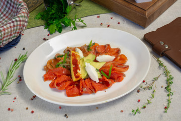 Red fish, slices, on a plate, appetizer, dinner in a restaurant
