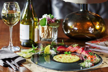 Dinner at the restaurant, dish and wine on the table