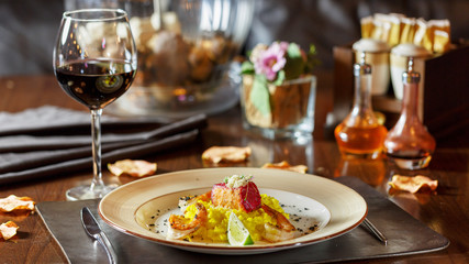 Dinner at the restaurant, dish and wine on the table