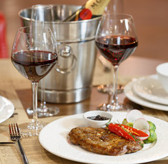 Dinner at the restaurant, dish and wine on the table