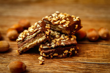 Chocolate cookies with hazelnut on wooden table. Close-up and vintage background.