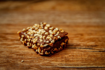 Chocolate cookies with hazelnut on wooden table. Close-up and vintage background.