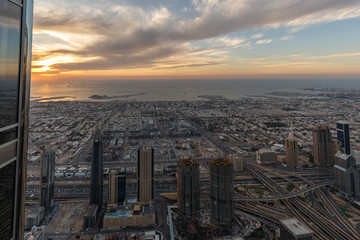 Naklejka na ściany i meble Dubai, UAE - APRIL 25, 2016: Dubai Skyline while the sunset in Dubai on April 25, 2016 in the United Arab