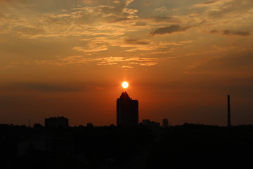clouds at dawn. Fiery red rising sun behind the clouds. headpiece