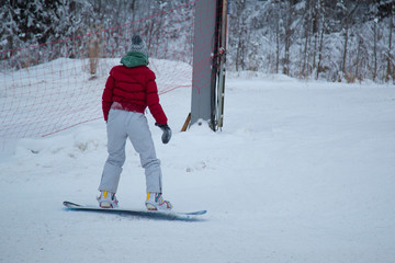 Fototapeta na wymiar a snowboarder rides a snowboard