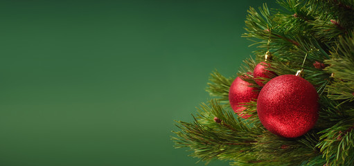 Decorated Christmas tree branches on green background. Christmas background with free space