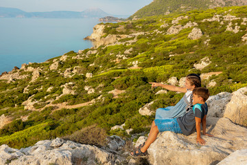 Naklejka na ściany i meble Young beautiful girl traveling along the coast of the Mediterranean Sea.