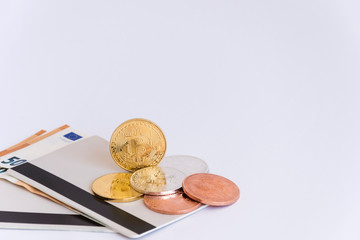 A handful of bitcoins on bank booklets.