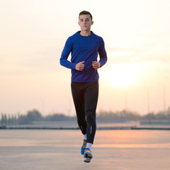 Young Sports Man Running at Sunset. Healthy Lifestyle and Sport Concept.