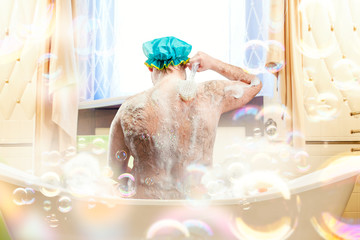 Fat ugly man washing in a bath