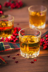 Whiskey, brandy or liquor shot and Christmas decorations