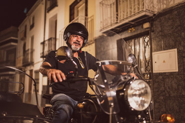 Fototapeta na wymiar Senior biker driving sidecar vehicle