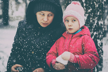 it is cold in winter, it is snowing. Girl and daughter, with a compass and odometer in his hand...