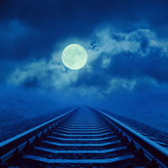 full moon in cloudy over night railroad