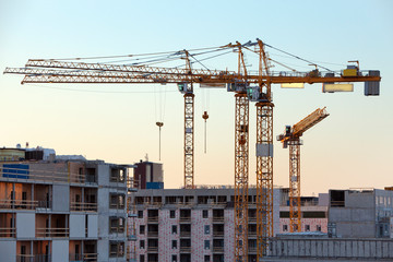 Fototapeta premium Construction cranes work in Helsinki in winter