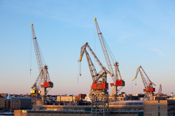 Fototapeta na wymiar Construction cranes work in the port of Helsinki in winter