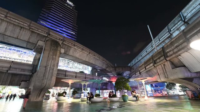 4K Night time lapse of crowd people walking and sky train traffic at Siam Square sky walk