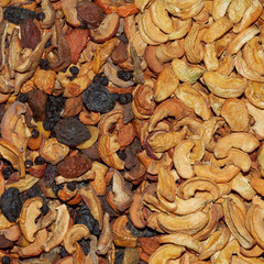 Mix of dried: apricots, apricot with a bone, dried apricot, prunes, apples, raisin, uruk. Dried fruit background.