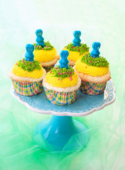 Easter cupcakes. Angel food cupcakes with yellow vanilla frosting and blue candy bunnies.