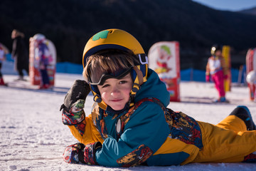 little snowboarder lying on the snow